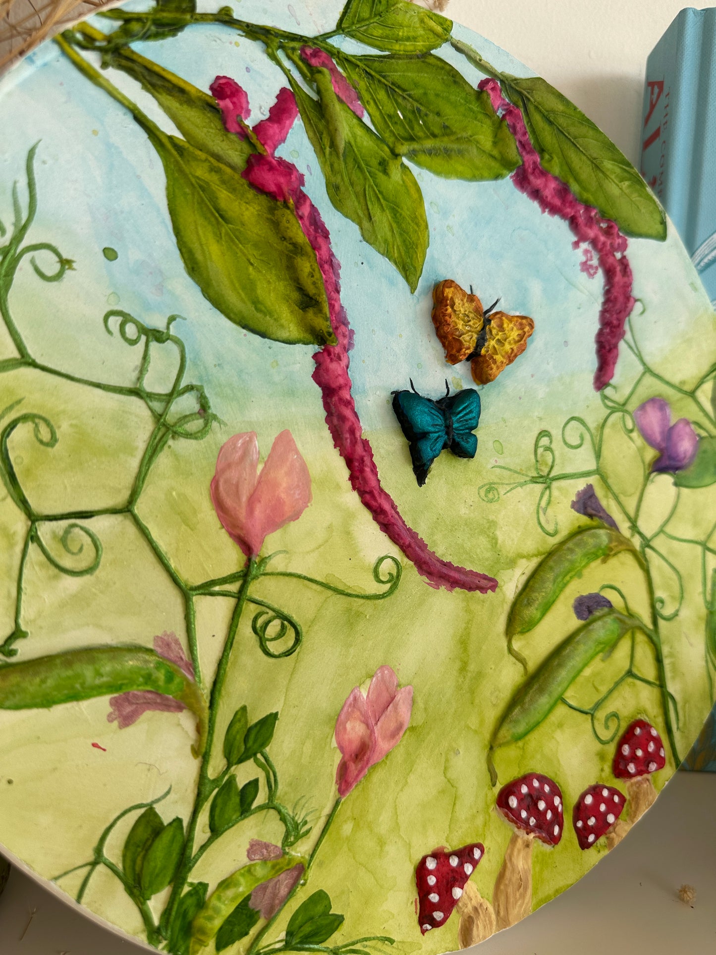 Framed Beneath the Blossoms art tablet styled against a natural backdrop